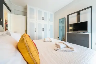a bedroom with a bed with two towels on it at Seaside Central Apartment in Athens