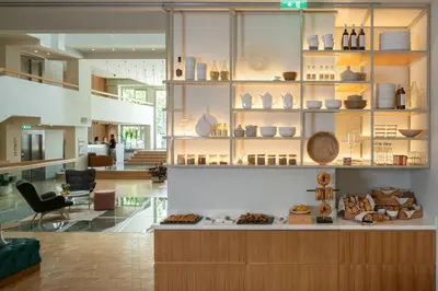 a kitchen with a counter with plates and bowls on shelves at Coco-mat Athens BC in Athens