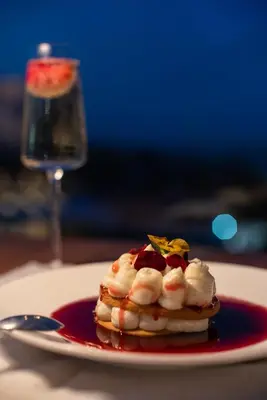a plate with a dessert on a table with a glass at Coco-mat Athens BC in Athens