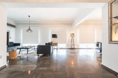 an open living room with a couch and a table at Traveler's Dream 4 brdm Renovated Penthouse in Athens