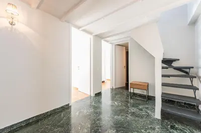 a staircase in a white room with a marble floor at Traveler's Dream 4 brdm Renovated Penthouse in Athens