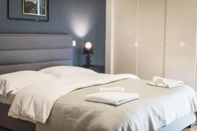 two white towels sitting on top of a bed at Traveler's Dream 4 brdm Renovated Penthouse in Athens