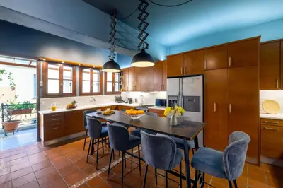 a kitchen with a large wooden table and chairs at Live Your Myth Under The Acropolis in Athens