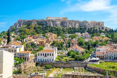 a view of a town with a mountain in the background at Mythos Luxury Suites in Athens