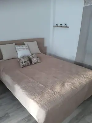 a large bed with two pillows on top of it at Fully renovated small & cosy studio in Athens