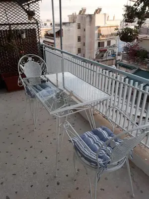 two chairs and a table on a balcony at Fully renovated small & cosy studio in Athens