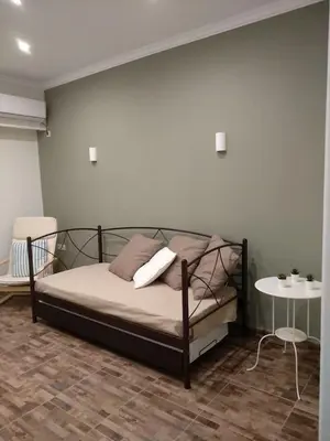 a bedroom with a bed and a table in a room at Athena's Home, Sunny Balkony 100m from metro! in Athens