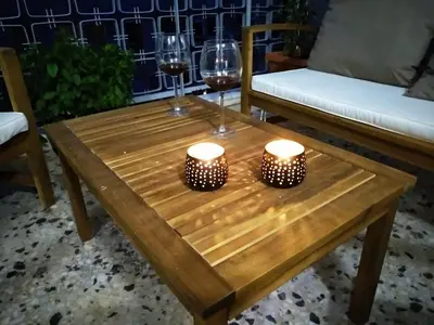 a wooden table with two glasses of wine and candles at Athena's Home, Sunny Balkony 100m from metro! in Athens