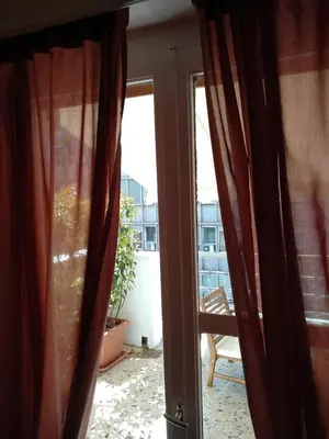 an open door to a balcony with a window at Athena's Home, Sunny Balkony 100m from metro! in Athens