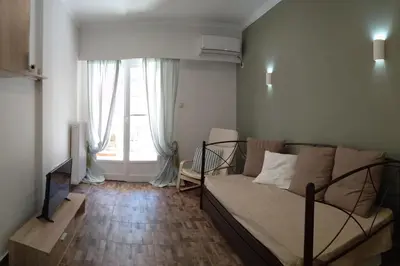 a living room with a bed and a window at Athena's Home, Sunny Balkony 100m from metro! in Athens
