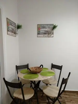 a table with chairs and a bowl of food on it at Athena's Home, Sunny Balkony 100m from metro! in Athens