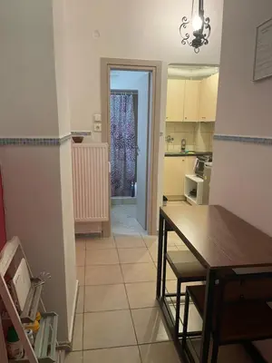 a kitchen with a table and a dining room at Angel Promachos by Acropolis in Athens