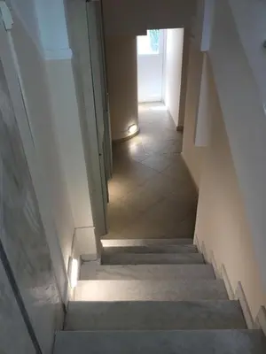 a staircase with a light at the end of a hallway at Angel Promachos by Acropolis in Athens
