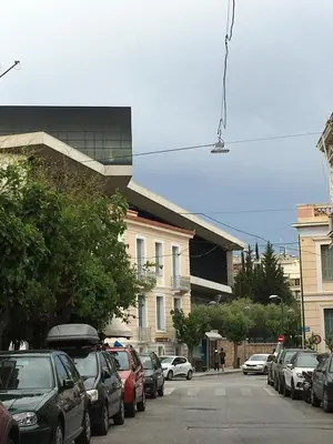 a street with cars parked on the side of the road at Angel Promachos by Acropolis in Athens