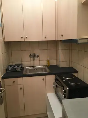 a small kitchen with a sink and a stove at Angel Promachos by Acropolis in Athens