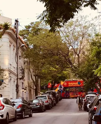 a city street with cars parked on the side of the road at Angel Promachos by Acropolis in Athens
