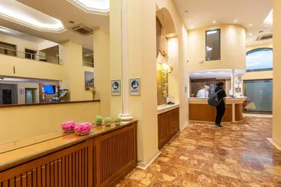 a woman standing in a waiting room at a salon at Hotel Marina in Athens