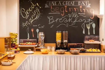 a buffet with a black chalkboard with food on it at Hotel Marina in Athens