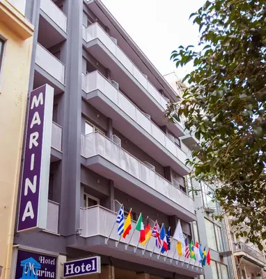 a hotel building with flags on a balcony at Hotel Marina in Athens