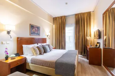 a hotel room with a bed and a window at Hotel Marina in Athens