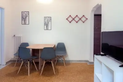 a dining room with a table and four chairs at Pnyka Apartment 2 in Athens