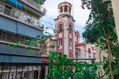 an old building with a clock tower in a city at Pnyka Apartment 2 in Athens