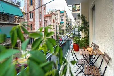 a balcony with two benches and a street with buildings at Pnyka Apartment 2 in Athens