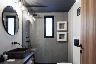 a bathroom with a sink and a mirror at Kolonaki 8 - Design Suites & Lofts in Athens