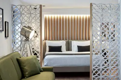a bedroom with a bed and a camera at Kolonaki 8 - Design Suites & Lofts in Athens