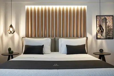 a bedroom with a large bed with white pillows at Kolonaki 8 - Design Suites & Lofts in Athens