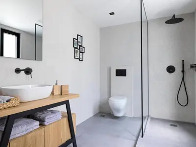 a bathroom with a sink and a glass shower at Kolonaki 8 - Design Suites & Lofts in Athens