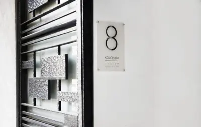 a black and white photo of a door with a clock at Kolonaki 8 - Design Suites & Lofts in Athens