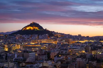 a view of a city with a mountain in the background at Kolonaki 8 - Design Suites & Lofts in Athens