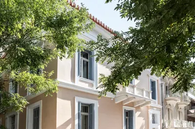 a large white building with a balcony at Monsieur Didot in Athens