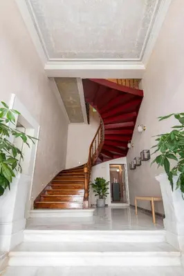 a staircase in a building with a red ceiling at Monsieur Didot in Athens