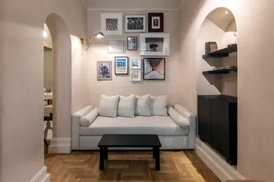 a living room with a white couch and pictures on the wall at Monsieur Didot in Athens