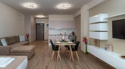 a kitchen and living room with a table and a couch at Amazing Apartments @ Monastiraki Subway Station in Athens