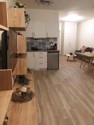 a kitchen with white cabinets and a wooden floor at Amazing Apartments @ Monastiraki Subway Station in Athens