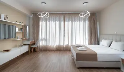 a bedroom with a bed and a desk and a television at Amazing Apartments @ Monastiraki Subway Station in Athens