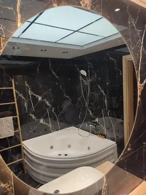 a mirror in a bathroom with a bath tub at Amazing Apartments @ Monastiraki Subway Station in Athens
