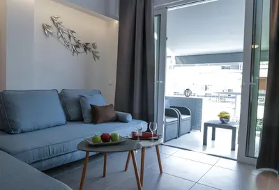 a living room with a couch and a table with fruit on it at V36 Suites in Athens
