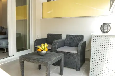 two chairs and a table with a bowl of bananas at V36 Suites in Athens
