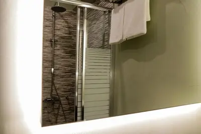 a mirror in a bathroom with a shower at V36 Suites in Athens