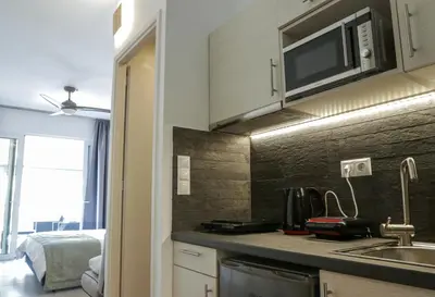 a kitchen with a sink and a microwave at V36 Suites in Athens