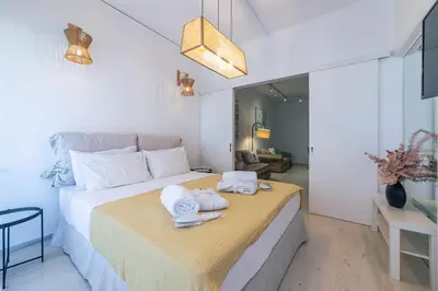 a bedroom with a bed with towels on it at L'appartement blanc dans le centre de Glyfada in Athens