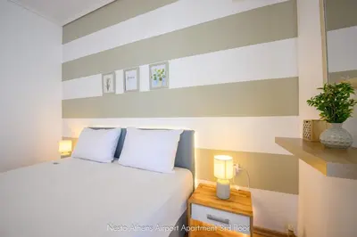 a bedroom with a bed with two white pillows at Nesto Athens Airport in Spáta