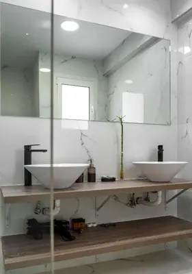 a bathroom with two sinks on a wooden counter at Amazing Apartments @ Aiolou Str. in Athens