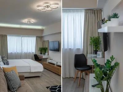 a bedroom and a living room with a bed and a tv at Amazing Apartments @ Aiolou Str. in Athens