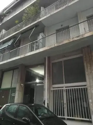 a car parked in front of a building at Cozy studio near Victoria metro station in Athens