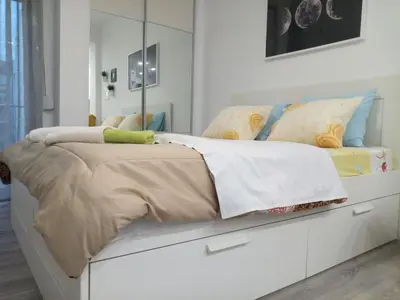a bedroom with a bed with a dresser at Cozy studio near Victoria metro station in Athens